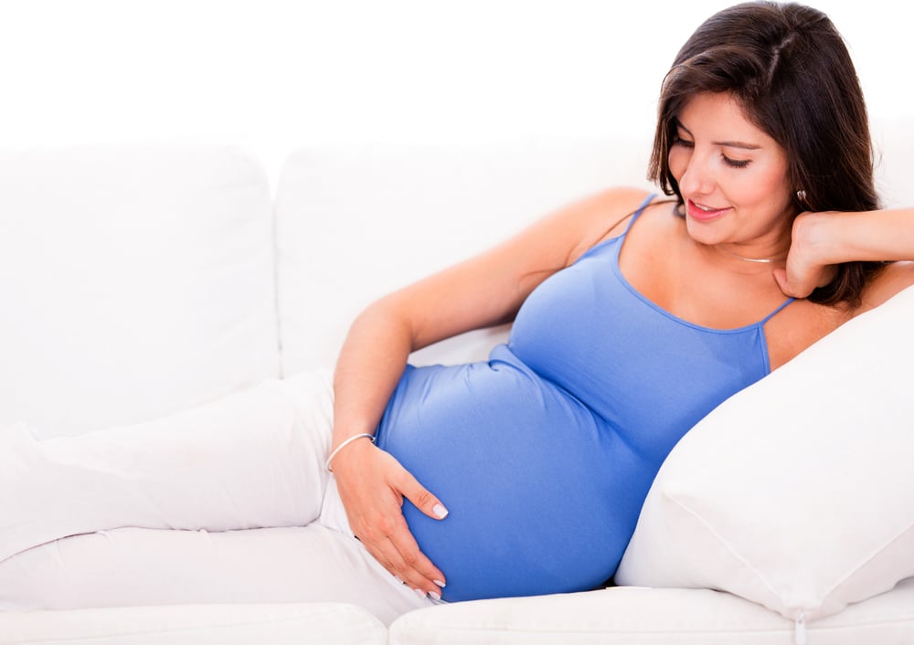 Pregnant woman relaxing at home on the couch